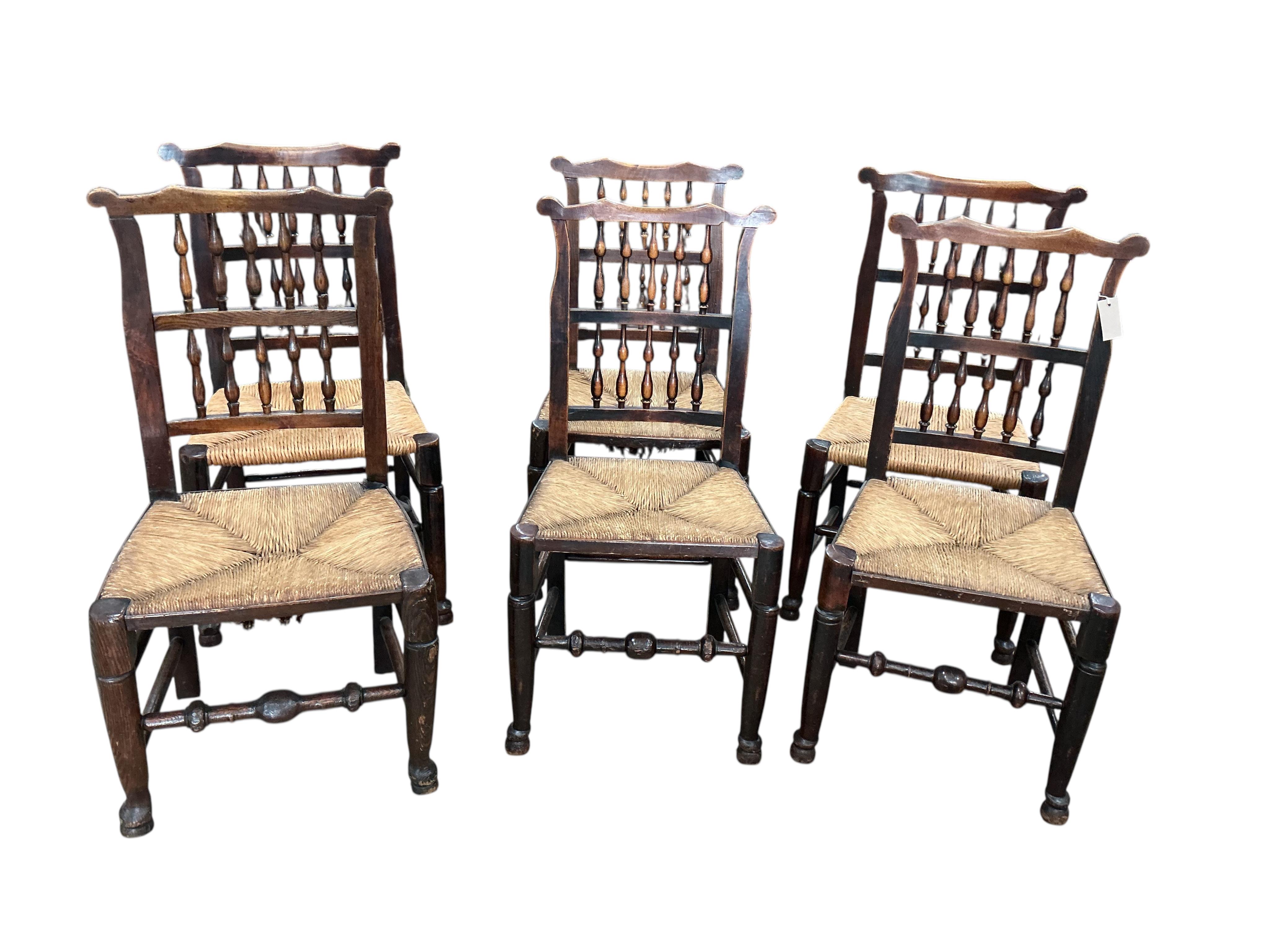 A harlequin set of six 19th century Lancashire beech and fruit wood rush seat dining chairs